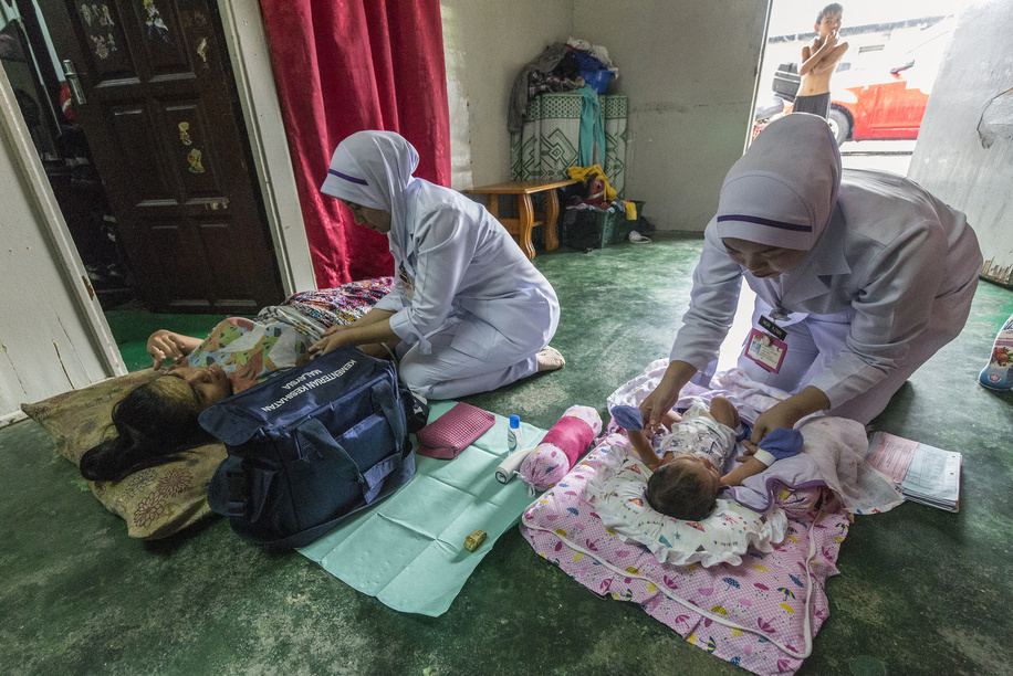 Nurses from the nearest health center on house call for post-natal care home to monitor the health status of the mother and child.