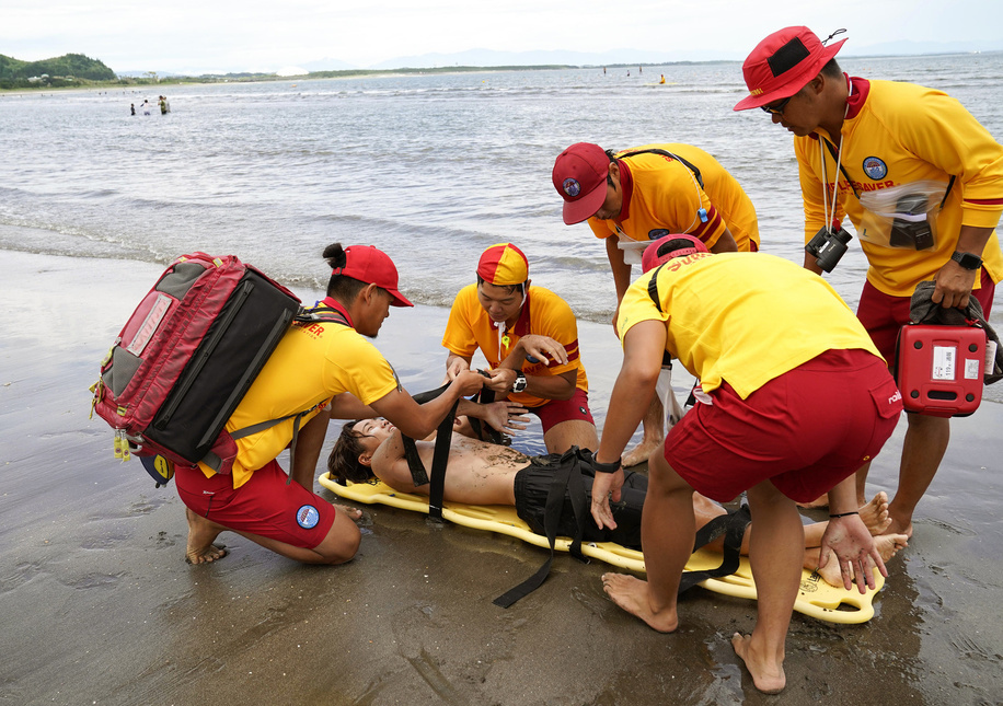 Lifesavers rescues a drowning swimmer during a mockup lifesaving practice at Aoshima Beach in Miyazaki, Miyazaki Prefecture, south western Japan, 10 July 2021. Japan Lifesaving Association has worked for drowning prevention program to educate new licensed lifesavers and conduct the junior programs for water safety as well as using and developing new technology to assist lifesaving activities.