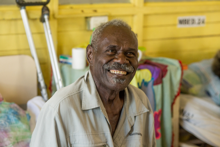 Herbert, a patient at the medical ward, smiles after receiving therapeutic treatment at the National Referral Hospital in Honiara, Solomon Islands. Disclaimer: This image was captured during the global response to the COVID-19 pandemic. The contents of this image reflect the guidance communicated by local public health authorities at the time of its capture. Please note, public health guidance differs among countries and is indicative of the local context.