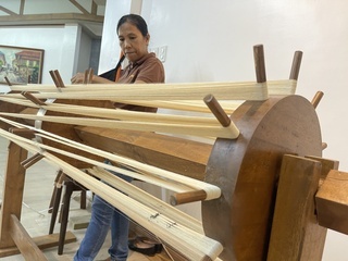 Artisan performing piña weaving, a craft on which pineapple fiber is woven to produce textile in Aklan, Philippines.