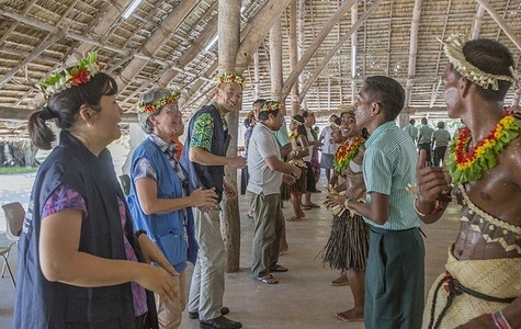 Students performing a traditional dance for WHO Western Pacific Regional Director Dr Takeshi Kasai and Hon. Tauanei Marea, Minister Health and Medical Services, at St Joseph's College school in Abaiang, an outer island of Kiribati.   Read more: https://www.who.int/westernpacific/news/item/25-02-2019-new-who-regional-director-meets-pacific-leaders-communities-highlights-climate-change-noncommunicable-diseases-emergencies-as-priorities Note: Title reflects the respective position of the subject at the time the photo was taken.