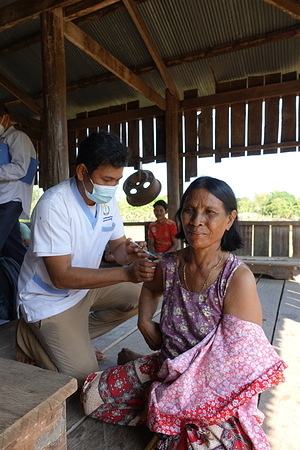 An elderly receives COVID-19 vaccination in Preah Vihear, Cambodia. Disclaimer: This image was captured during the global response to the COVID-19 pandemic. The contents of this image reflect the guidance communicated by local public health authorities at the time of its capture. Please note, public health guidance differs among countries and is indicative of the local context.