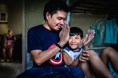 Baltazar Lucas, living with hepatitis B, survivor of liver cancer who went through a liver transplant. He plays with his son at home. WHO works closely with the Philippine Department of Health (DOH) to address the public health problem of viral hepatitis in the country through strengthened policies, plans, and surveillance of the disease.   Read feature story: https://www.who.int/philippines/news/feature-stories/detail/surviving-hepatitis-b-and-liver-cancer-vhal-s-story