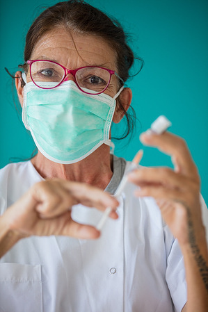 A nurse prepares a dose of the COVID-19 vaccine at the Moorea Hospital. Disclaimer: This image was captured during the global response to the COVID-19 pandemic. The contents of this image reflect the guidance communicated by local public health authorities at the time of its capture. Please note, public health guidance differs among countries and is indicative of the local context.