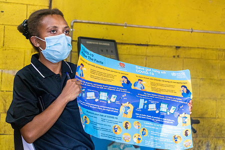 Clare Valaki, Health Extension Officer of Businesses for Health (B4H), presents a poster outlining COVID-19 safety and awareness to the workers of K.R Tyre Services in Port Moresby, Papua New Guinea.  With the support of World Health Organization, B4H started the ‘Small Business Project’ to educate businesses about COVID-19 infection prevention and control.   Read photo story: https://www.who.int/westernpacific/news-room/photo-story/photo-story-detail/papua-new-guinea--the-one-on-one-personal-approach-goes-to-work-for-covid-19-protection Watch: https://www.youtube.com/watch?v=1ZvDUZ7WFsc Disclaimer: This image was captured during the global response to the COVID-19 pandemic. The contents of this image reflect the guidance communicated by local public health authorities at the time of its capture. Please note, public health guidance differs among countries and is indicative of the local context.