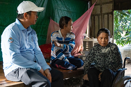 (From left) Visal So speaks to Limchork and Vit at their house in Preaek Ta Baen Village. Visal is a social mobilizer, physical therapist, and program officer of National Leprosy Elimination Program (NLEP). In his role, he supports case detection, rehabilitation, and uses a compassionate people-centered approach that builds relationships with people affected by leprosy throughout Cambodia. Visal’s experience exemplifies how passion and care as a health worker can support patients who experience multidimensional stigma and discrimination. In Cambodia, WHO supports the Ministry of Health’s NLEP with the implementation of activities aimed at addressing stigma and discrimination experienced by people affected by leprosy.    Read more: https://www.who.int/westernpacific/news-room/feature-stories/item/caring-for-communities--a-tailored-approach-to-leprosy-elimination-in-cambodia Watch https://www.youtube.com/watch?v=DesgSkXbDcw&t=10s