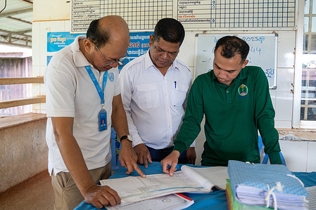(From left) Chan Sophal, Ouch Savern and Sithon Makara consults the malaria register to plan the outreach work within the community. Sophal is a WHO field staff for malaria elimination who works on the ground serving vulnerable and hard-to-reach communities. Who’s WHO video series tells the story of WHO workforce and the work they do to promote health, keep the world safe, and serve the vulnerable. In an elimination setting like Cambodia, communities must travel long distances to the nearest centre to access malaria services. The immense dedication of health workers are essential for eliminating malaria in the Greater Mekong subregion by 2030.    Watch https://www.who.int/westernpacific/news-room/multimedia/overview/item/reaching-out-to-remote-communities-to-eliminate-malaria#